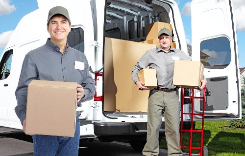 Mover handling a large item during a scheduled van service